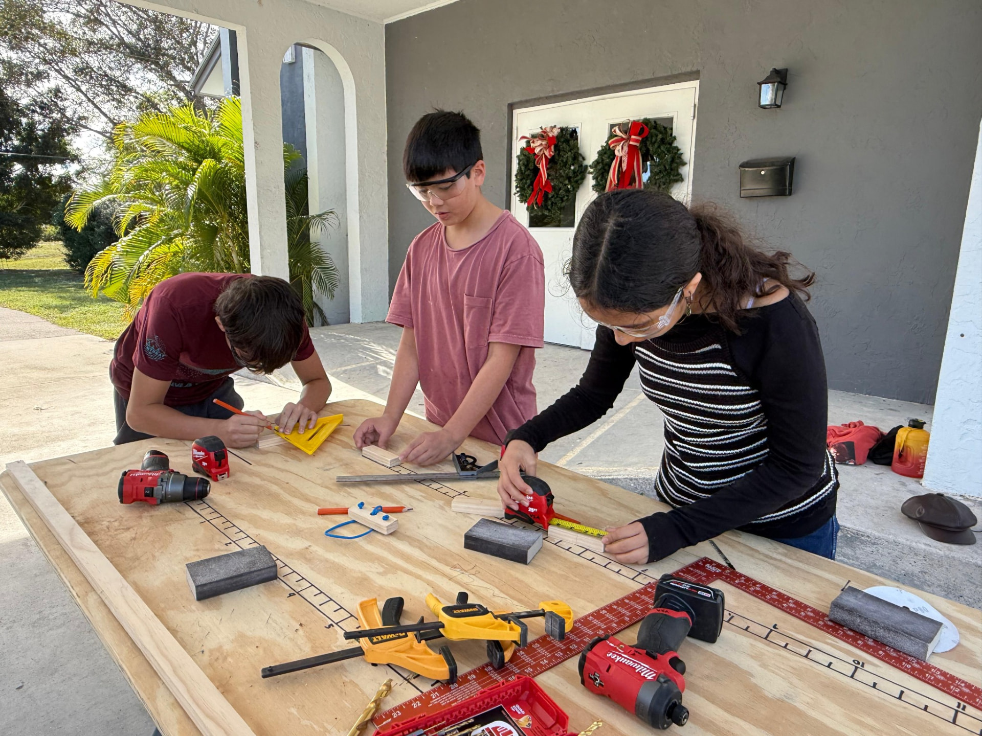 Older Connect students working together on a woodworking project