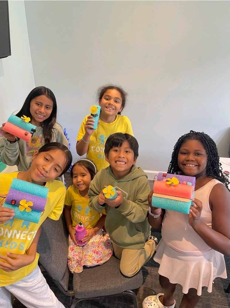 Connect students holding their finished craft projects
