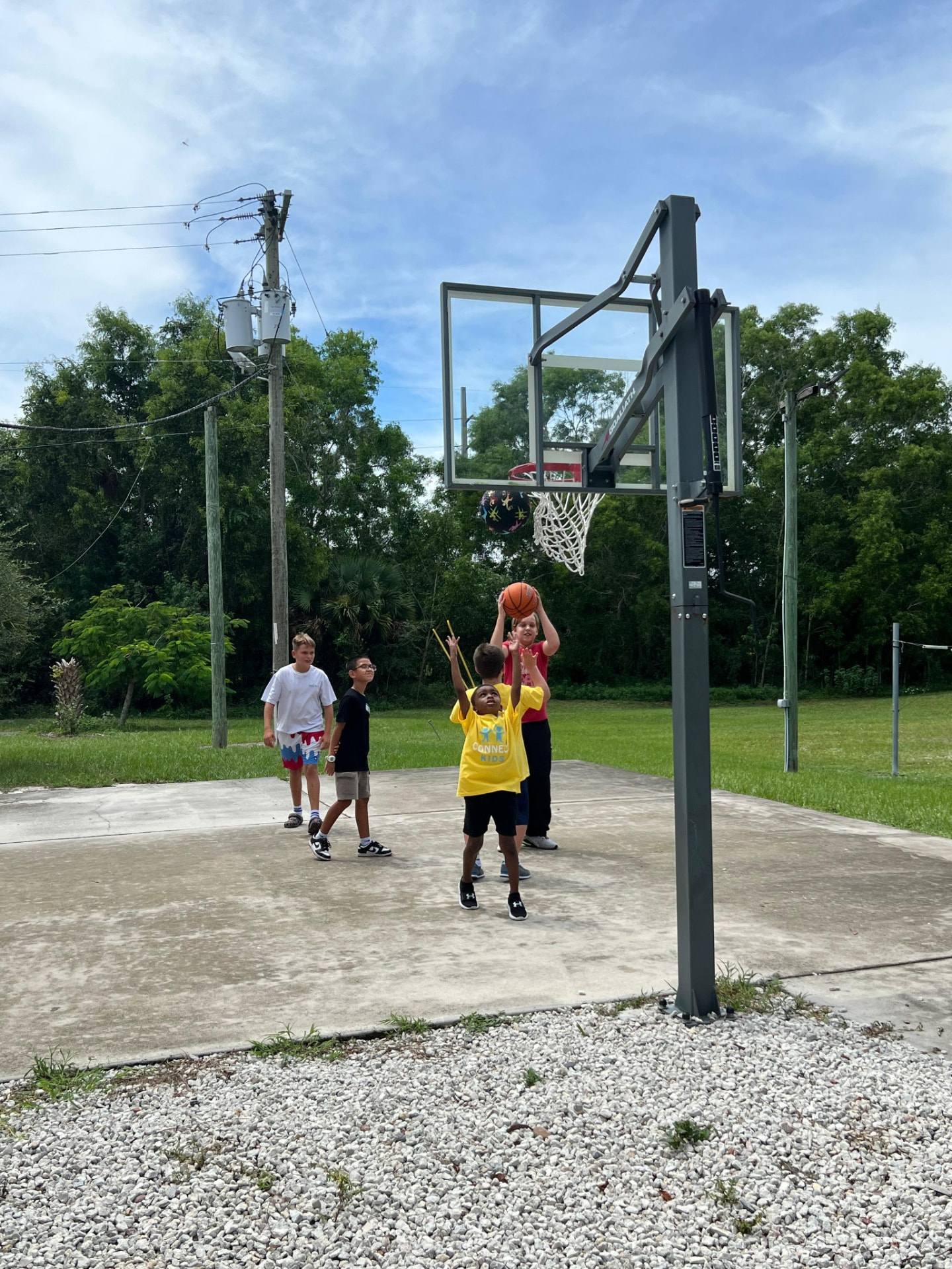 Connect students playing basketball outdoors